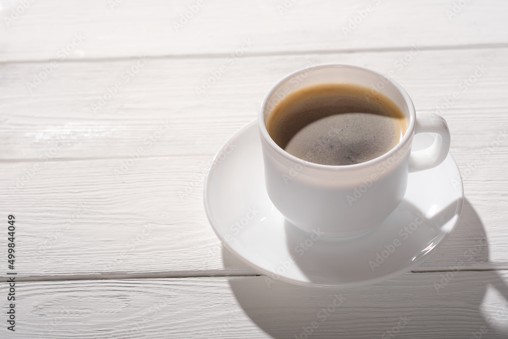 espresso coffee in a white classic cup on rustic wooden table. good morning, natural sunlight. copy space espresso coffee in a white classic cup on rustic wooden table. good morning, natural sunlight. copy space