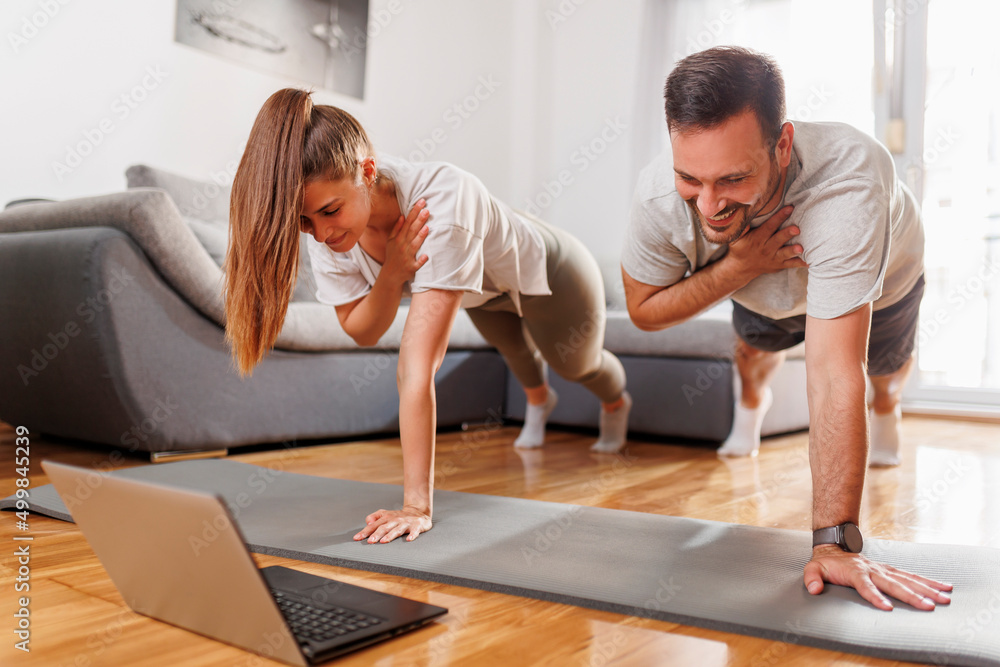 Couple doing online yoga course Couple doing online yoga course