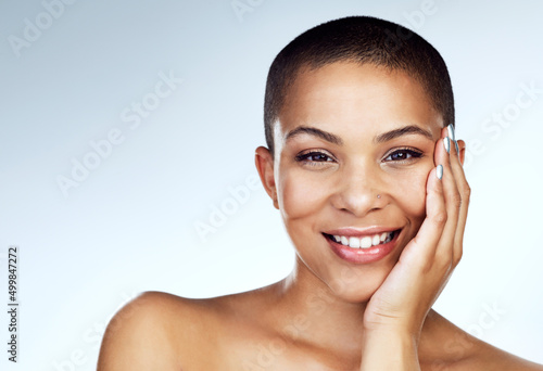 Your beauty is something that should be appreciated. Shot of a beautiful young woman touching her face against a grey background.