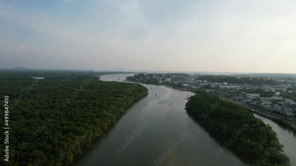 Aerial drone panning up over an island in the middle of a river and mangrove forest on a sunset afternoon in Krabi Town Thailand Aerial drone panning up over an island in the middle of a river and mangrove forest on a sunset afternoon in Krabi Town Thailand