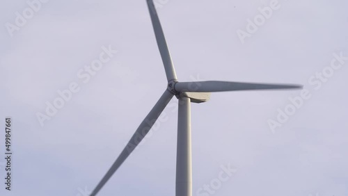 Bird getting close to rotating wind turbine in Gismarvik Norway - Static closeup of Enercon wind turbine producing renewable electricity