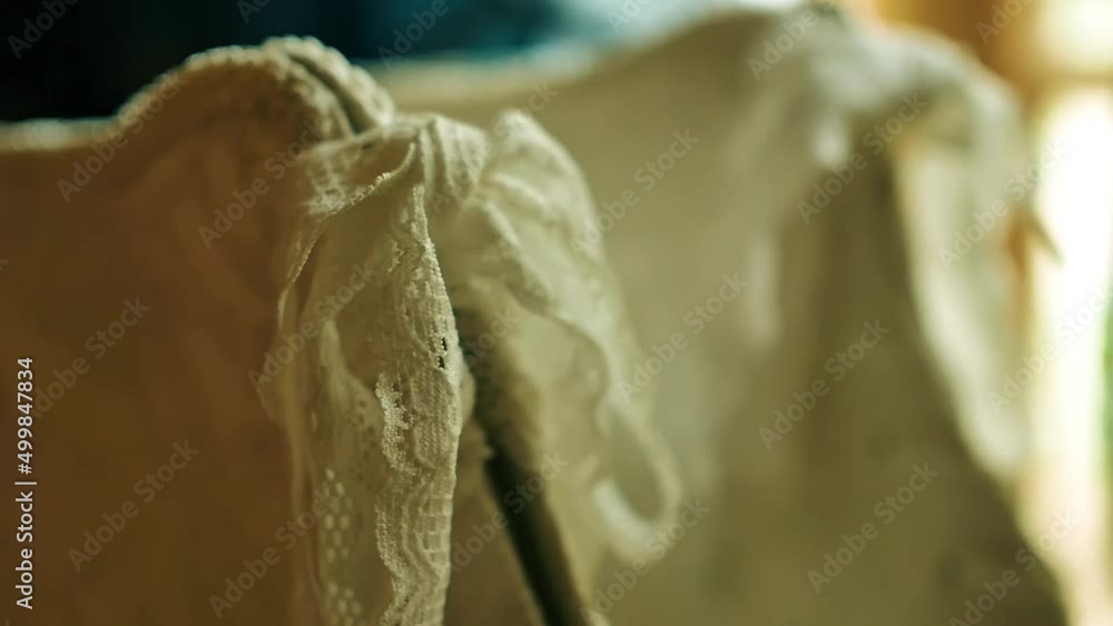 Close up of a elegant wedding dress hanging outside on a fall day as bride prep for a wedding ceremony. Close up of a elegant wedding dress hanging outside on a fall day as bride prep for a wedding ceremony.