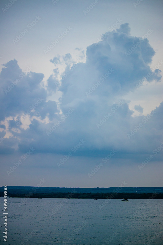 large clouds over fishing boats