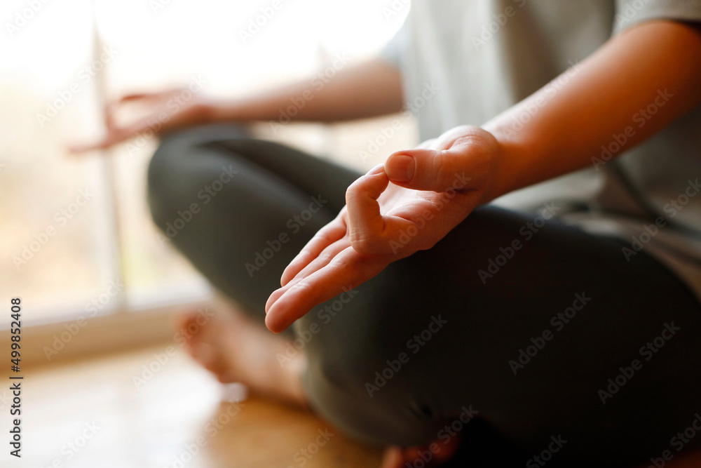 Close-up of woman's hand during meditation sitting on windowsill. Mental healthcare concept. Close-up of woman's hand during meditation sitting on windowsill. Mental healthcare concept.