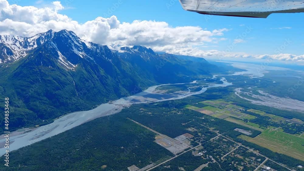 Small airplane flight over the edge of the town of Palmer Alaska, flying over the Knik River with the end of Cook Inlet in the far distance. Small airplane flight over the edge of the town of Palmer Alaska, flying over the Knik River with the end of Cook Inlet in the far distance.