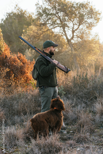 Man hunting with purebred dog in countryside