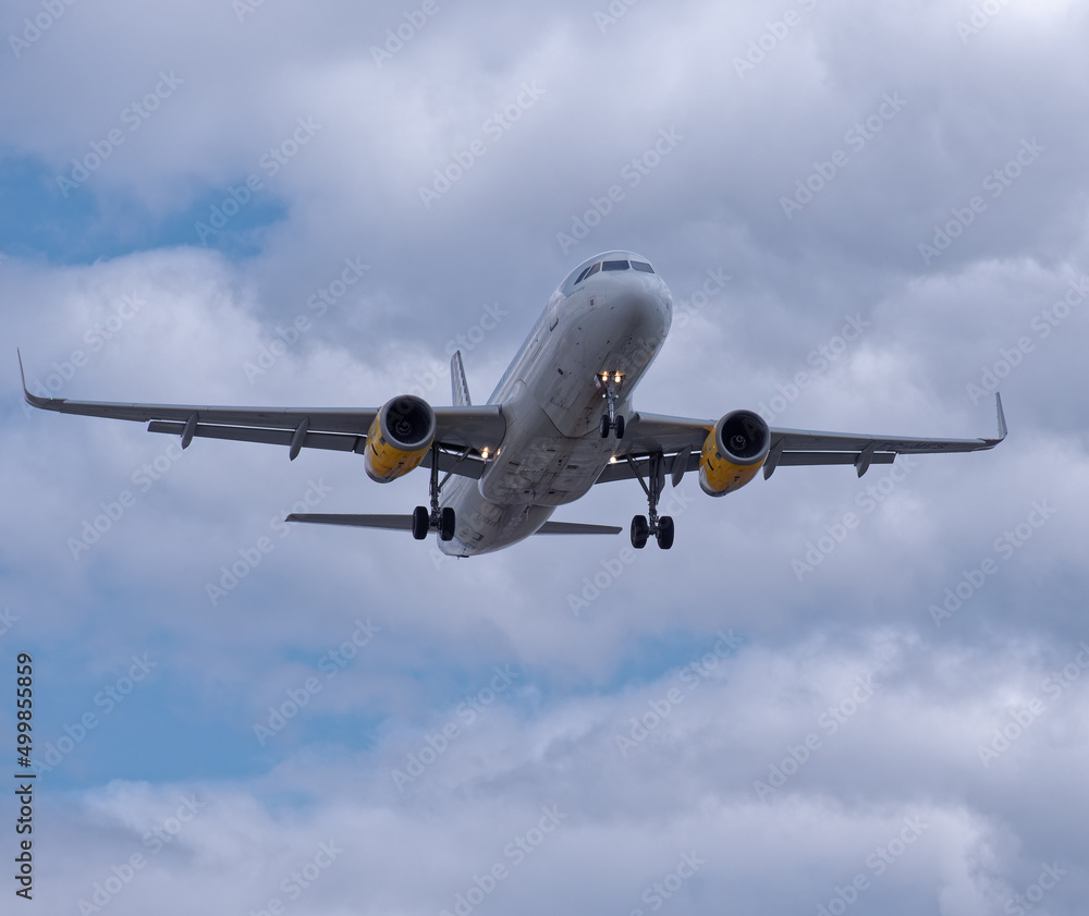 Holiday passenger jet plane landing at Manchester international airport