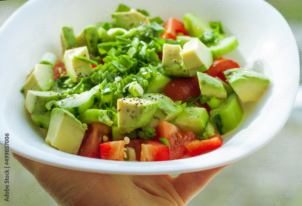 fresh salad with tomatoes and cucumbers and avocado