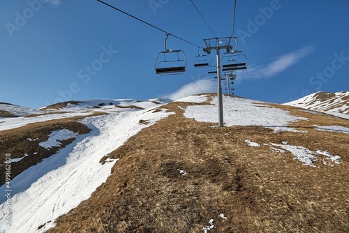 Obraz na plátne Ski lift at a ski resort with little snow