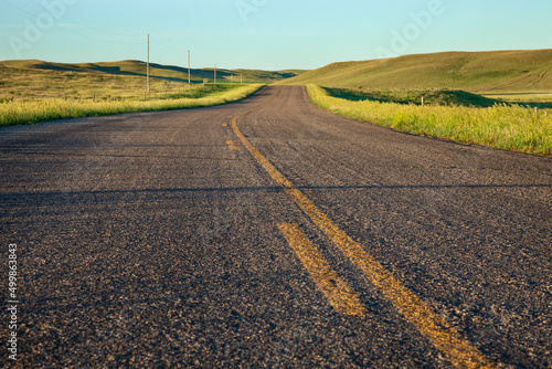 Low angle view of a country road with curves in South Dakota on a summer morning