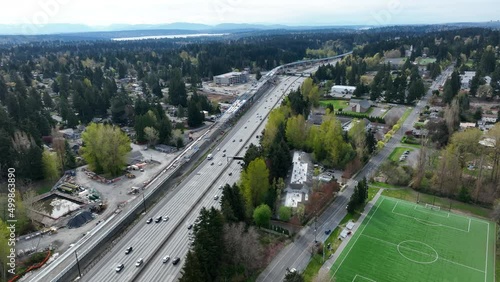 Cinematic drone dolly shot of Sound Transit Shoreline South 145th Light Rail Station construction near Paramount Park, Parkwood, Ridgecrest, Evergreen, Seattle suburbs by I-5 freeway, Washington photo