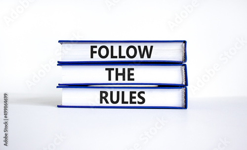Follow the rules symbol. Concept words Follow the rules on books. Beautiful white table white background. Business and follow the rules concept. Copy space.