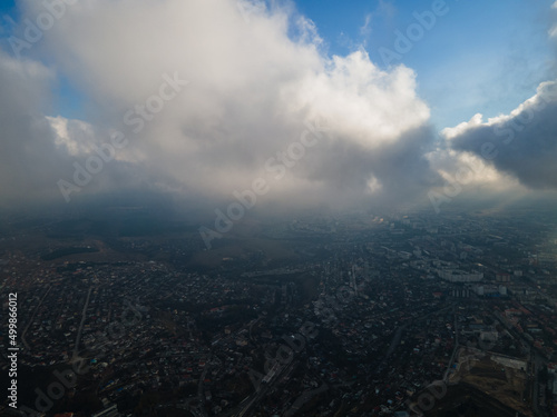 A magical flight in the clouds over the city. The sun s rays are beautifully reflected from the clouds. Above the sky. Fluffy clouds. shooting at high altitude.