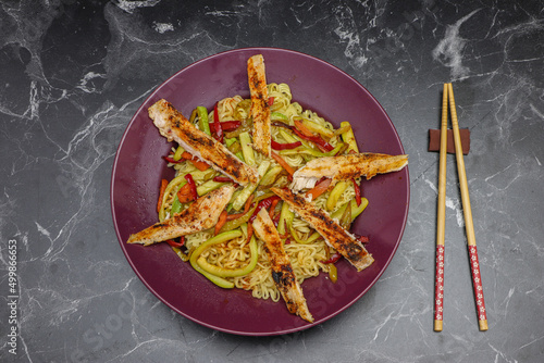 Bowl of chicken veggie noodles photo