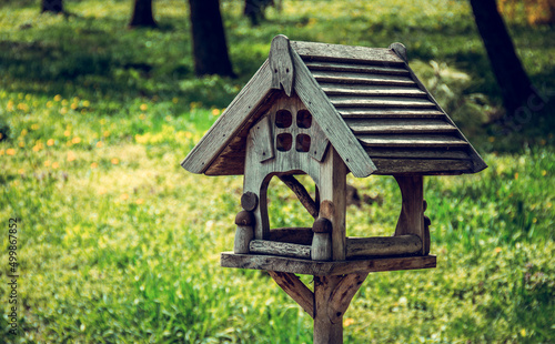 Wooden bird feeder. Beautiful wooden birdhouse © alatielin