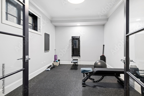 Simple Home Gym. Small room in basement with workout equipment.