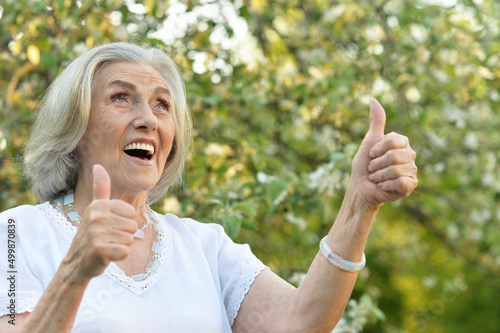 Portrait of happy senior beautiful woman in spring park