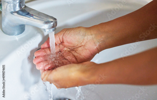 Know the worth of water before all wells run dry. Cropped shot of an unrecognizable male washing his hands in a hand basin at home.