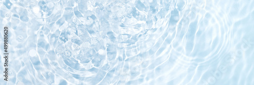 Blue water banner, clean and transparent surface with circles from drops, flat lay