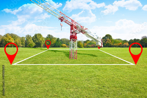 Land plot management - real estate concept with a vacant land on a green field available for building construction and tower crane