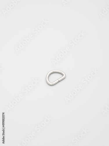 Metal accessories and supplies for bags, backpacks and sewing laying on a grey background. Chrome-plated metal frames for handbags straps. Sewing, bags making, copy space