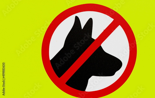 A sign prohibiting dog walking in a public place. The image of a dog in a circle crossed with a line.