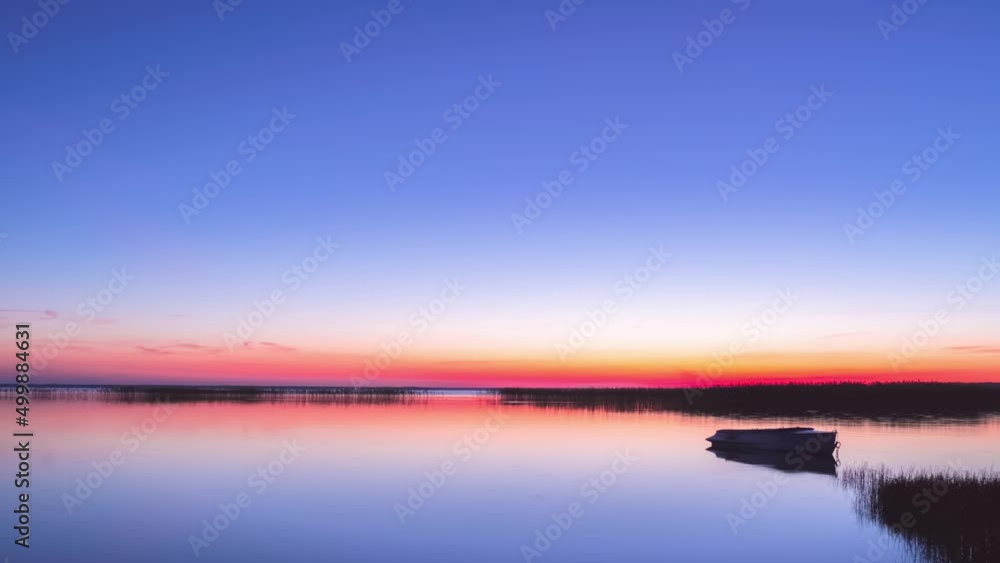 Sunrise on flat lake with boat. Timelapse Sunrise on flat lake with boat. Timelapse