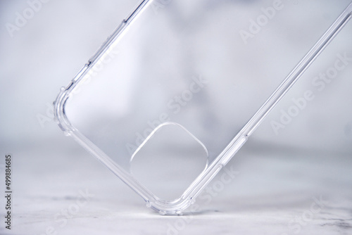 Close-up of a transparent silicone smartphone case on a marble background.