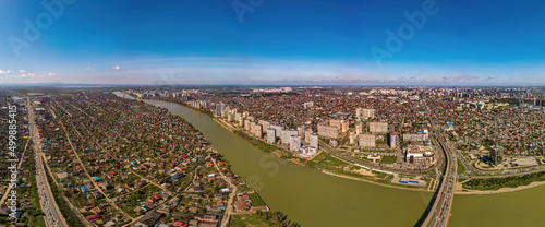 Large aerial panorama of the Kuban River near the Turgenev bridge in the city of Krasnodar on a sunny April day