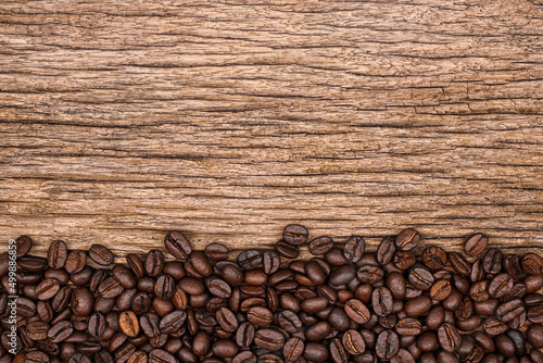 coffee beans on wood background space for sample text. top view. Agriculture, coffee shop concept.