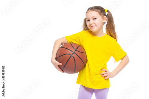 Little cute girl holding a basketball in her hand. Isolated on white background. © satyrenko
