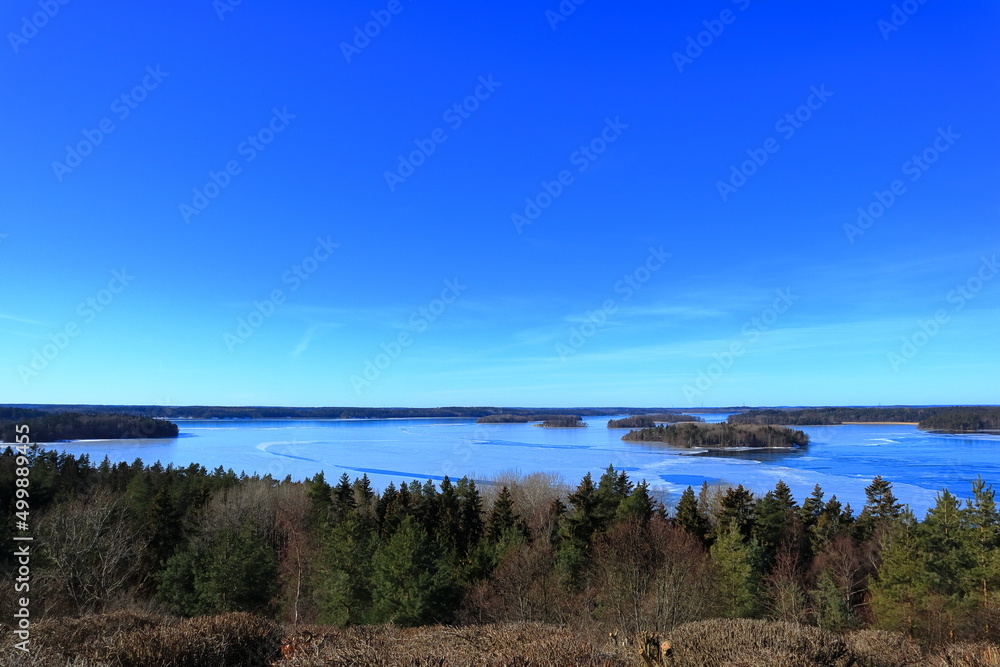 Great view over a Swedish landscape during the spring. Ice is still left on the lake. Blue sunny day. Mälaren, Stockholm, Sweden.