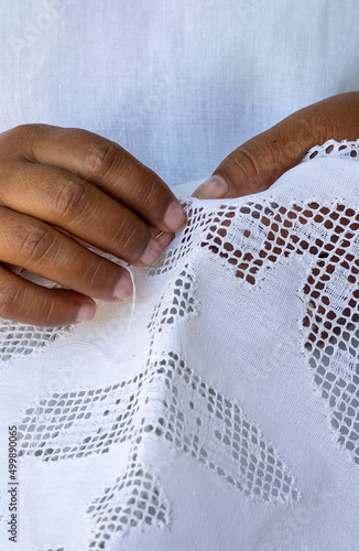 Handmade brazilian renaissance lace. Craftsman hands in close-up. Brazilian handicraft.