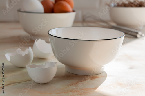Wallpaper Mural Eggs in a ceramic cup close-up. Cooking in the kitchen. White and brown eggs. Sunny morning. Preparing breakfast. selective focus Torontodigital.ca