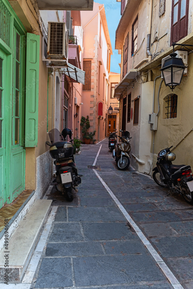 narrow cobbled street with parked motorcycles in the small Greek town of Rethymno