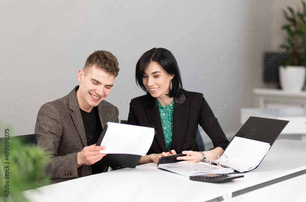Businessman and businesswoman meeting in modern office working on laptop, business meeting Businessman and businesswoman meeting in modern office working on laptop, business meeting