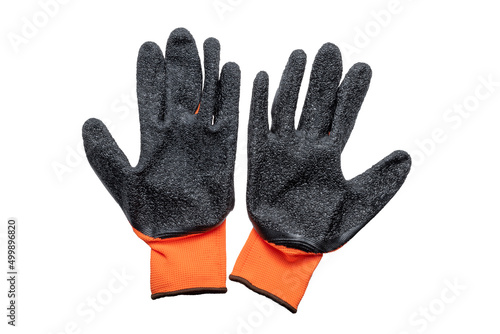 New nylon orange work gloves with a black latex coating, lying next to each other with the working side up. Isolated on white background.