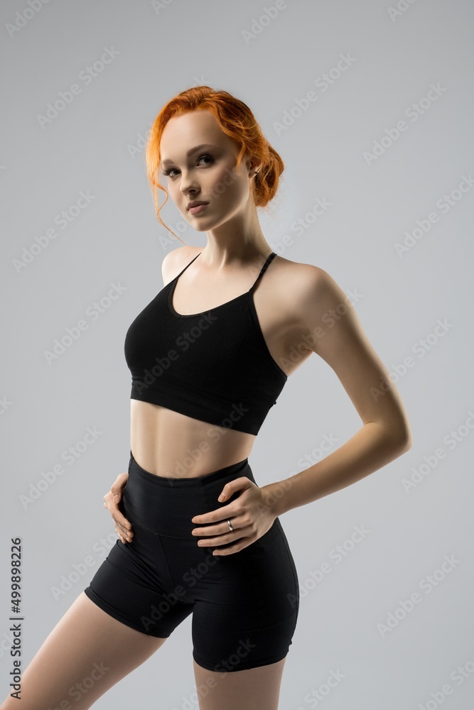 Serious young sportswoman in black sportswear look at camera Serious young sportswoman in black sportswear look at camera