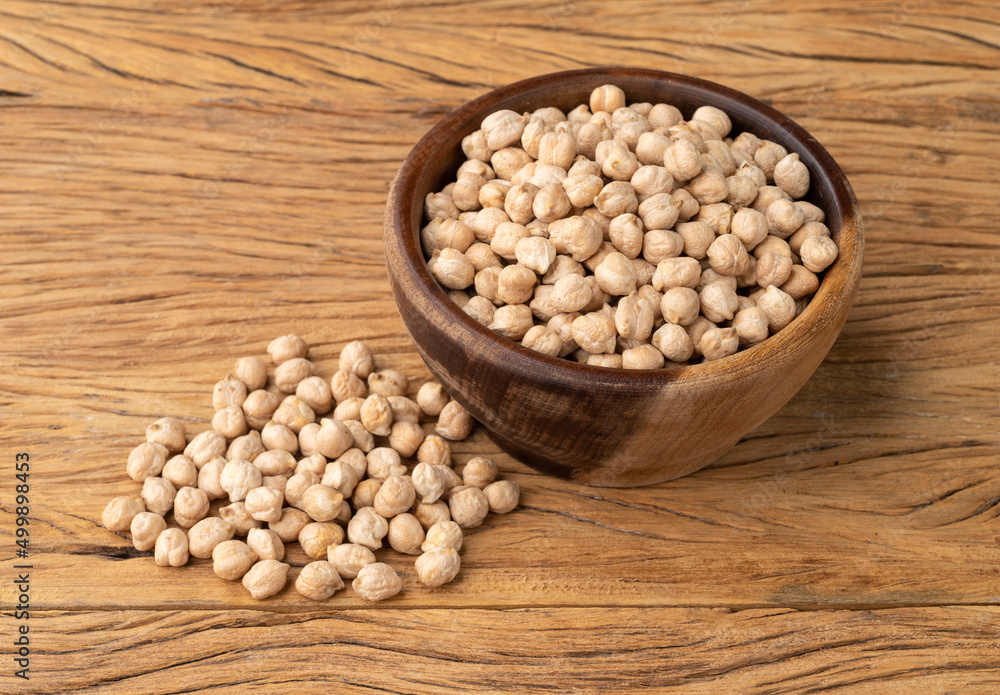 Raw chickpeas on a bowl over wooden table Raw chickpeas on a bowl over wooden table