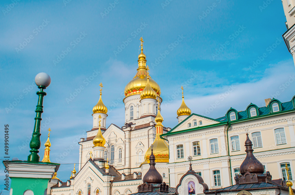 Orthodox Christian cathedral with golden domes. Side view.  Religious buildings. Holy Dormition Pochaiv Lavra in Ukraine.