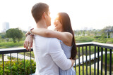 Multiethnic couple embracing in an urban park during sunset