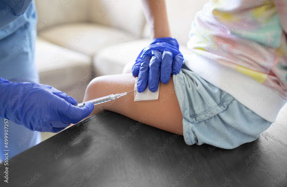 child getting shot vaccine in leg child getting shot vaccine in leg