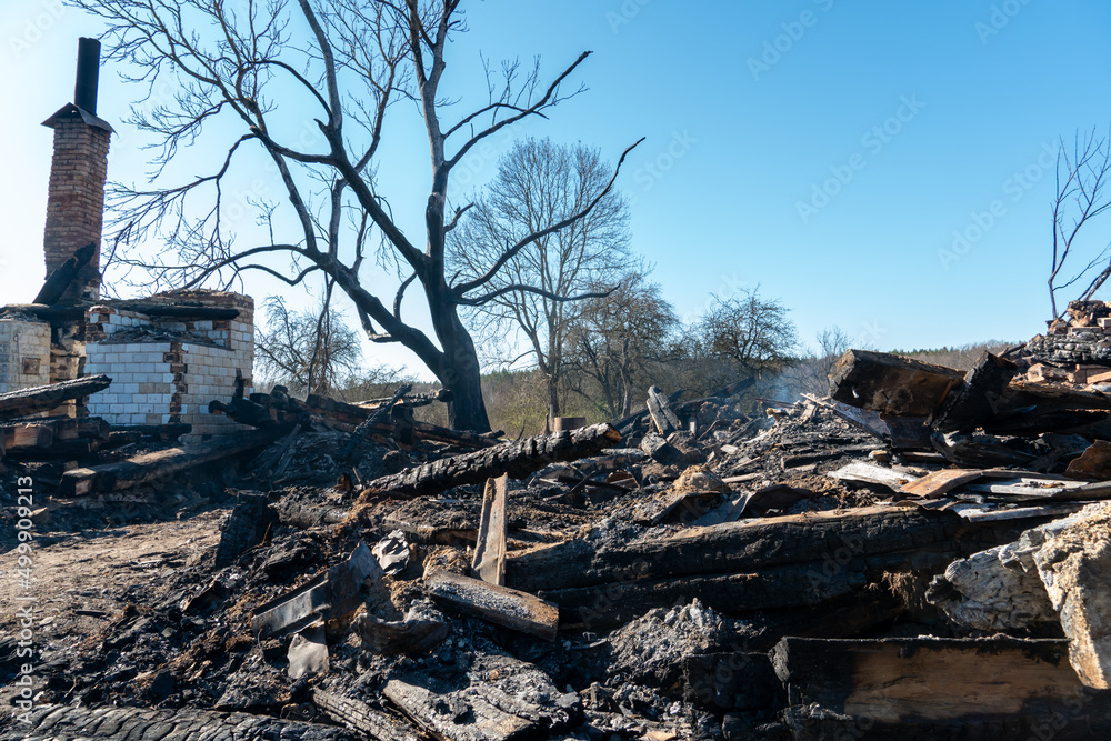 Various burnt things after the fire are scattered on the ground. A destroyed private house after being hit by an artillery shell. Consequences of the war in Ukraine. Various burnt things after the fire are scattered on the ground. A destroyed private house after being hit by an artillery shell. Consequences of the war in Ukraine.