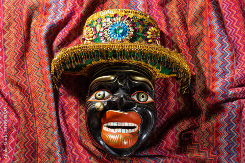 Typical Cusco´s mask on a traditional peru fabric