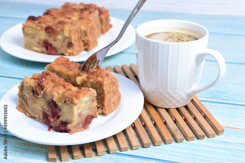 Fluffy bread cake with guava flavor accompanied by a cup of coffee on a wooden background Fluffy bread cake with guava flavor accompanied by a cup of coffee on a wooden background