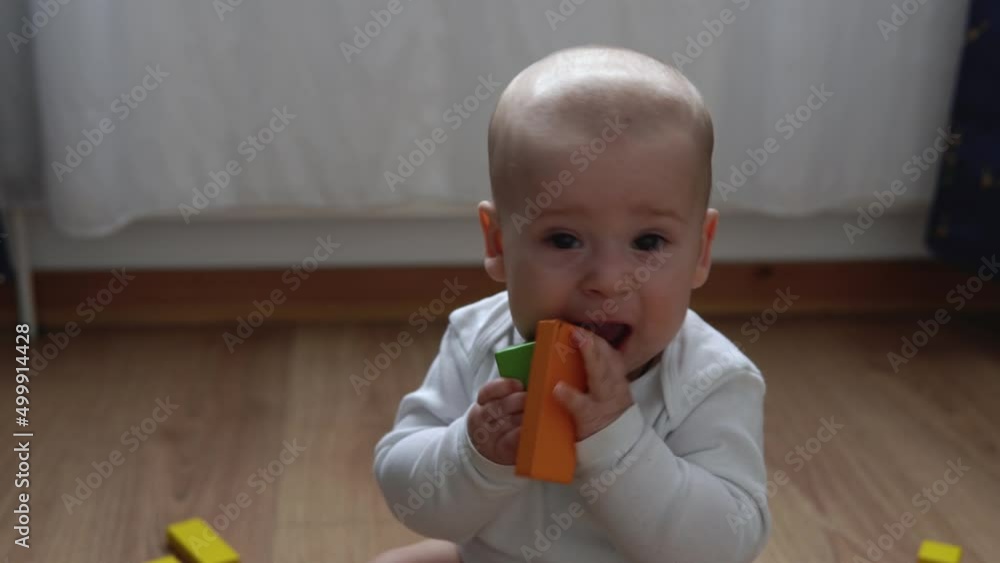 Happy Newborn Baby In Playing Room. Infant Kid Play With Wooden Toys At Home Build Constructions From Geometric Figures. Child Have Spend Time During Motor Skills Game. Childhood, Parenthood Concept Happy Newborn Baby In Playing Room. Infant Kid Play With Wooden Toys At Home Build Constructions From Geometric Figures. Child Have Spend Time During Motor Skills Game. Childhood, Parenthood Concept