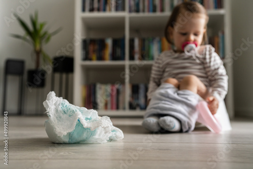 Photos baby diapers selective focus with small child in background sitting on the child