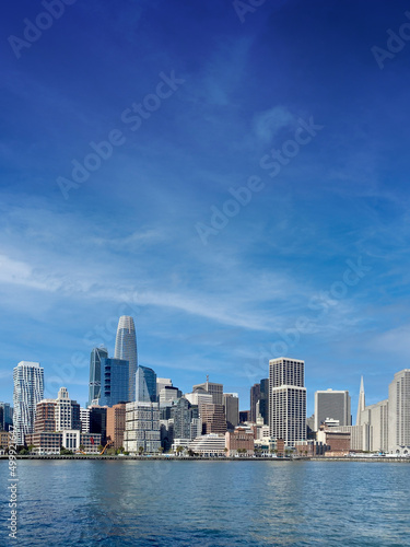 Boat level view of San Francisco, California downtown district and its skyscrapers and San Francisco bay in early morning © Allen.G