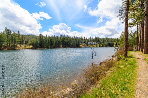 Waterfront luxury homes in the mountains of North Idaho along the Spokane River viewed from the public Kiwanis Park in the rural town of Post Falls, Idaho, USA. photo