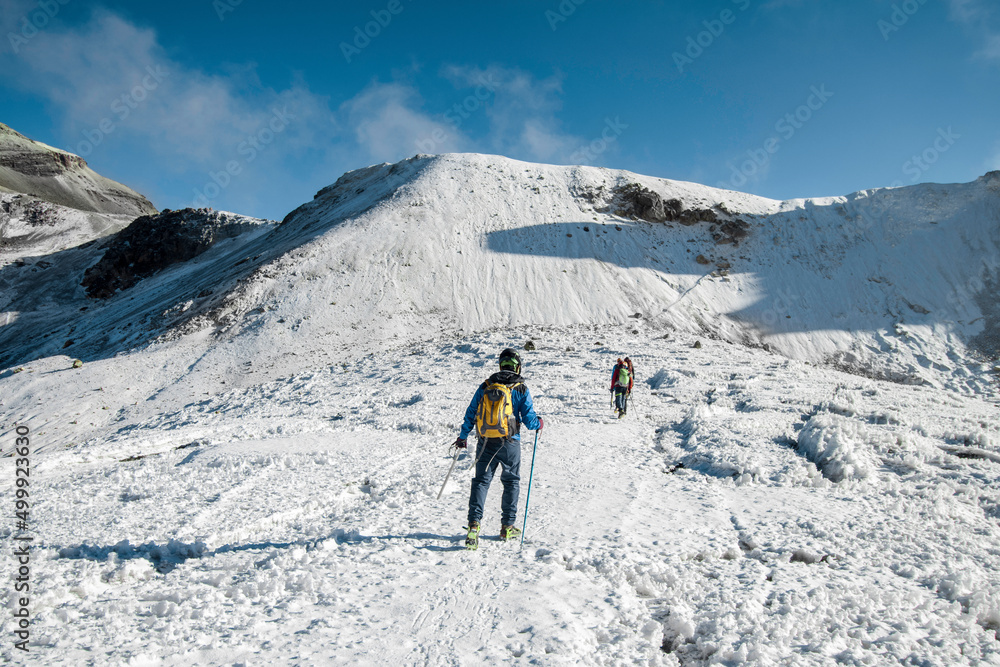 group of mountaineers walking through a glacier the mountains of Iztaccihuatl - Popocatepetl National Park in Mexico